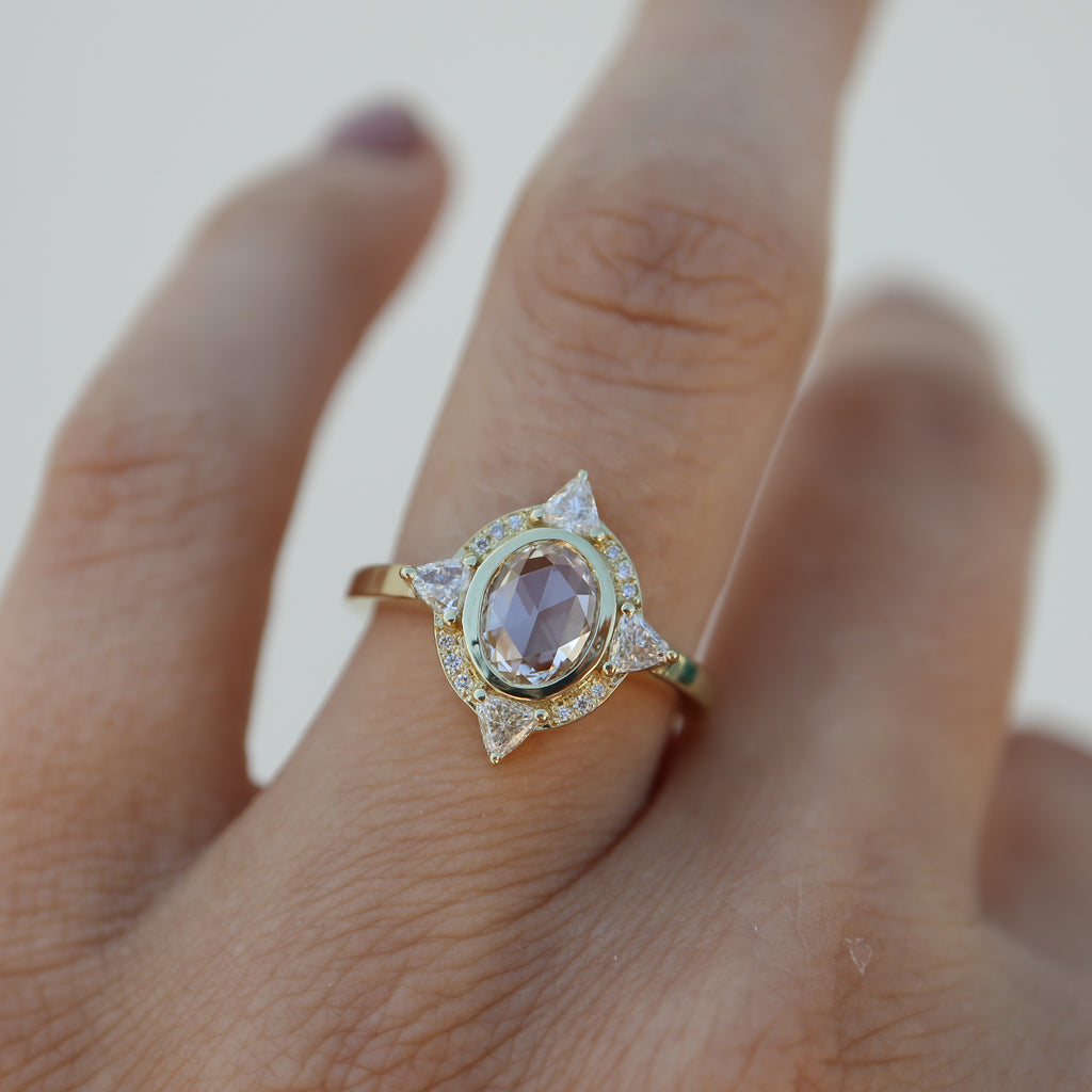 White Diamond sapphire engagement ring on model’s ring finger.